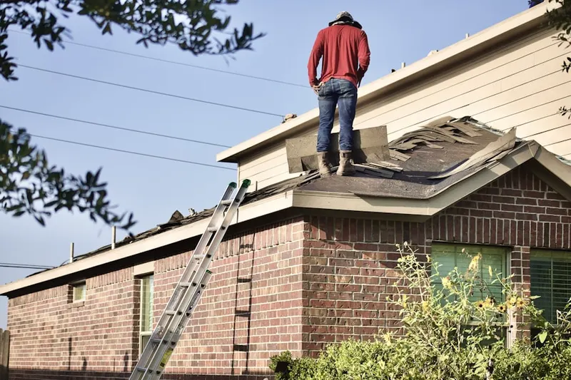Professional roofer working on a residential roof in Bernardsville